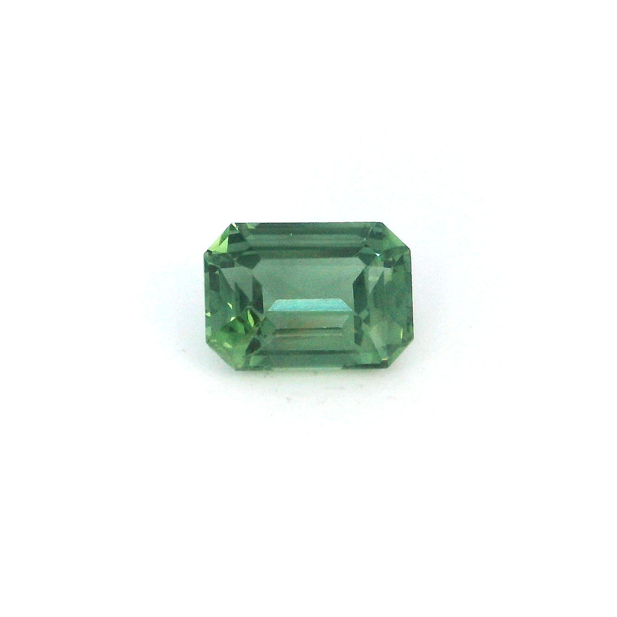 Octagon green sapphire gemstone on white background