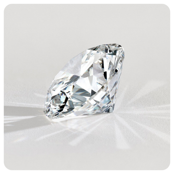 Clear round brilliant diamond on a light gray background